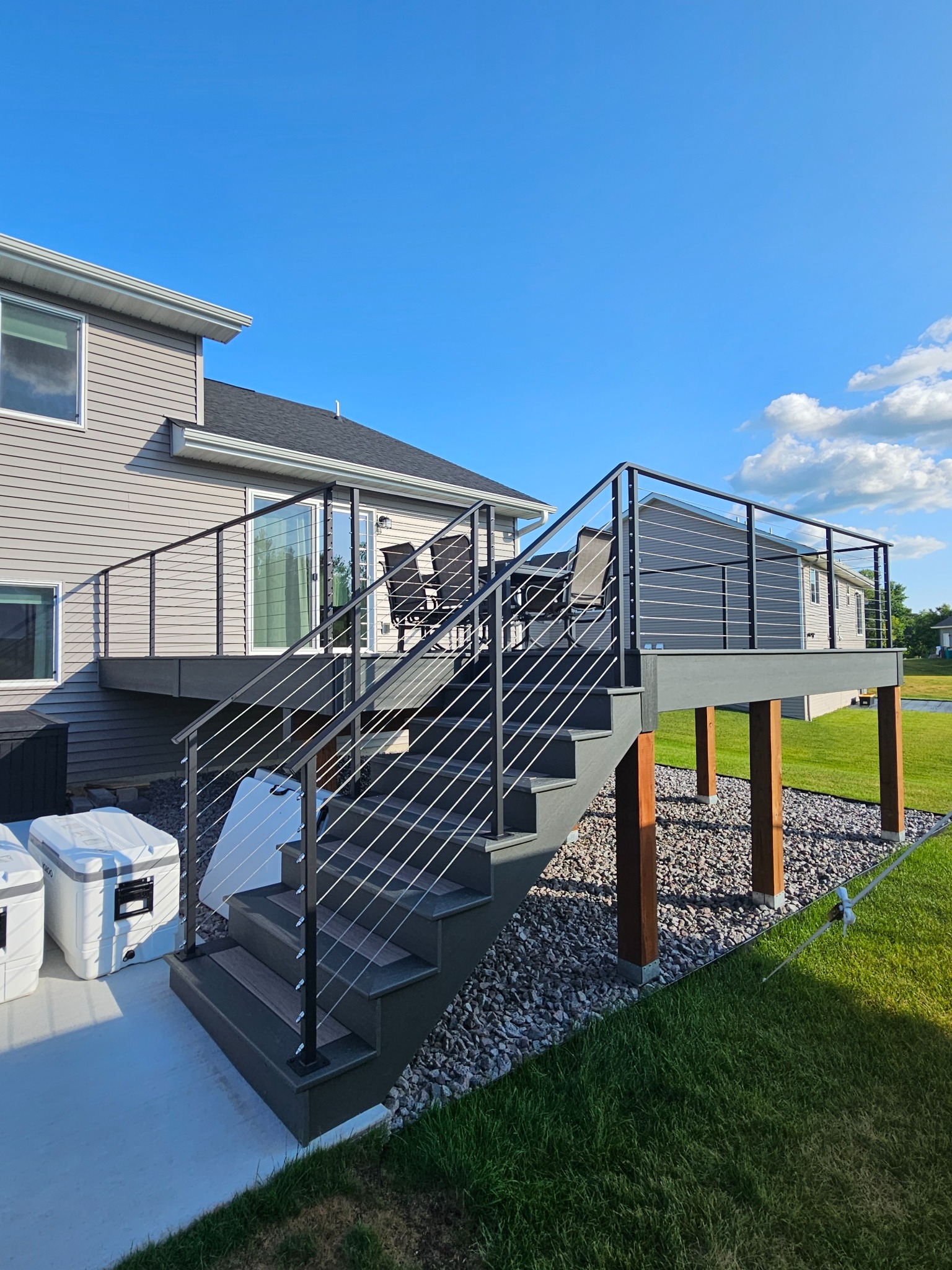 Black custom cable railing on a residential deck and stair