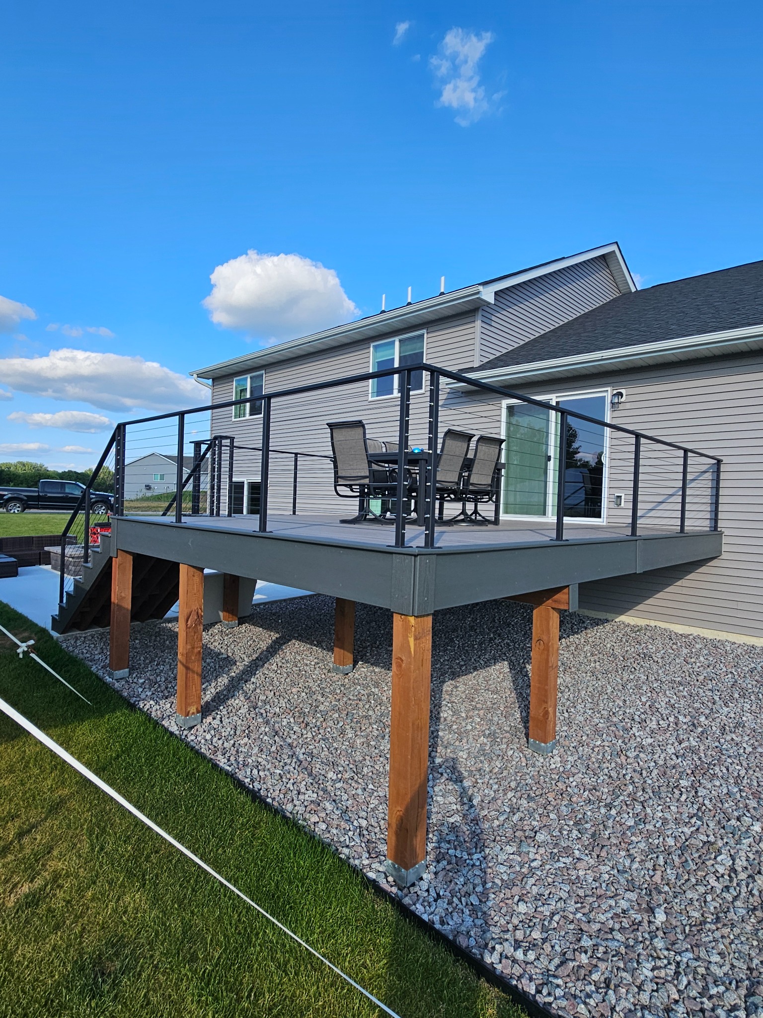 Black cable railing wrapping a residential deck
